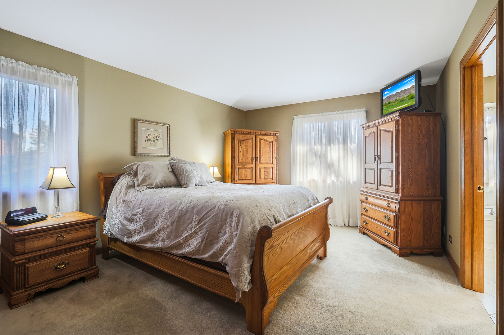 437 High Road Cary, IL 60013 - Photo 17 of 48 a spacious bedroom with a bed and a window