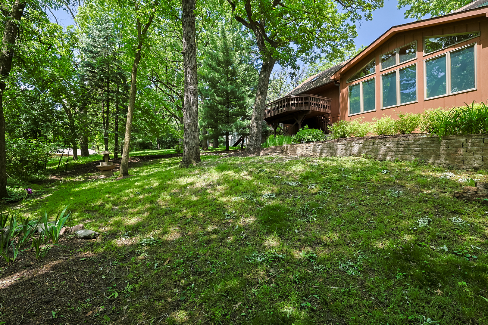 437 High Road Cary, IL 60013 - Photo 45 of 48 a backyard of a house with plants and large trees