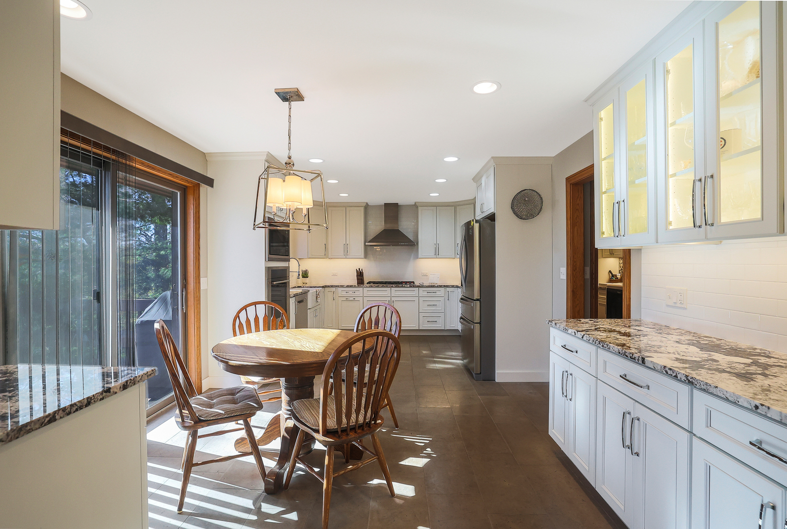 437 High Road Cary, IL 60013 - Photo 7 of 48 a dining room with granite countertop furniture and a chandelier