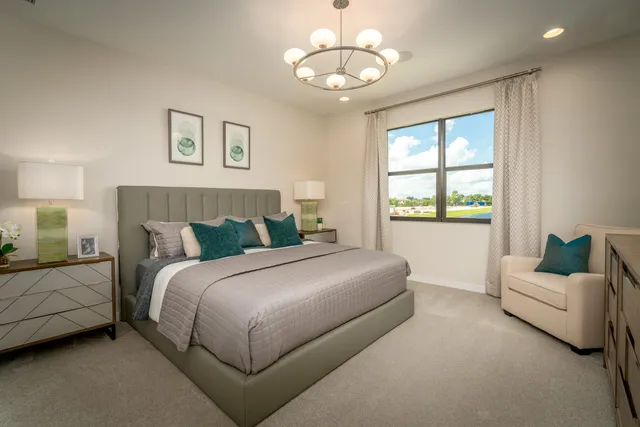 a bedroom with a bed and a chandelier