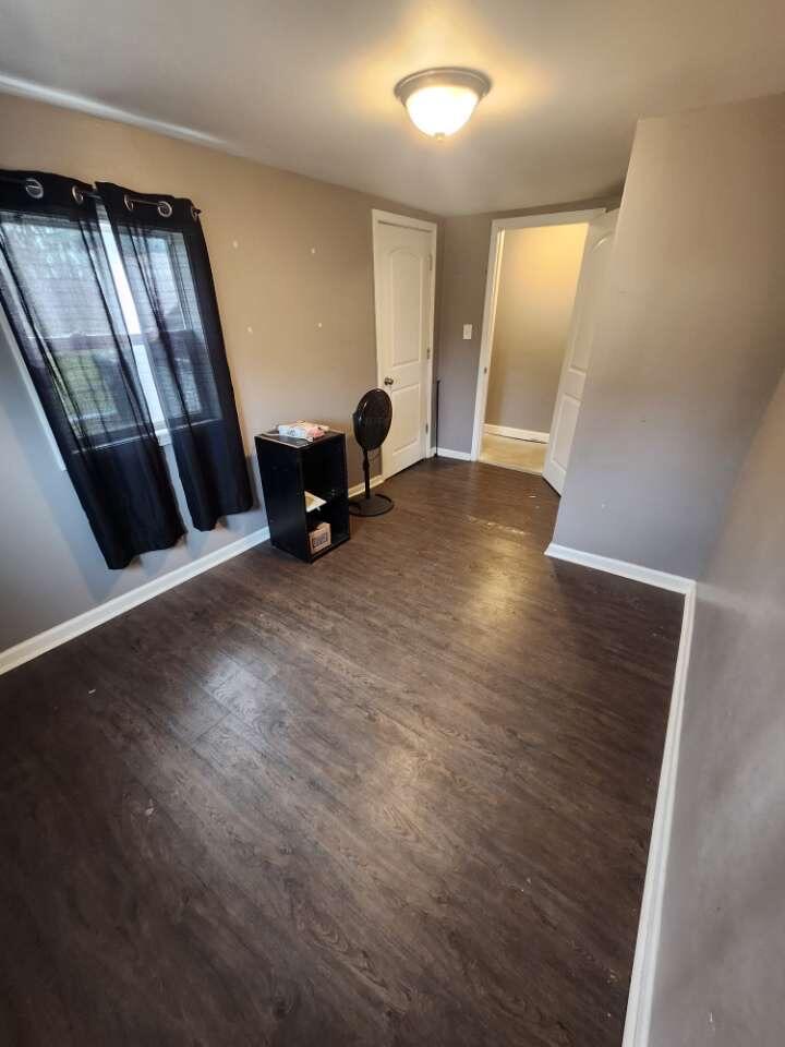 201 East 13th Place Hobart, IN 46342 - Photo 6 of 9 a view of an empty room with wooden floor