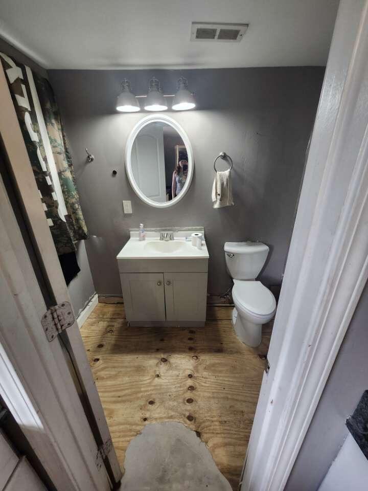 201 East 13th Place Hobart, IN 46342 - Photo 7 of 9 a bathroom with a toilet a sink and a mirror