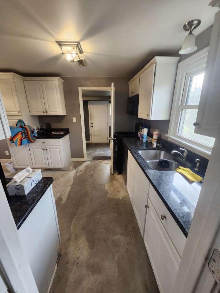 201 East 13th Place Hobart, IN 46342 - Photo 8 of 9 a large kitchen with a stove and a sink
