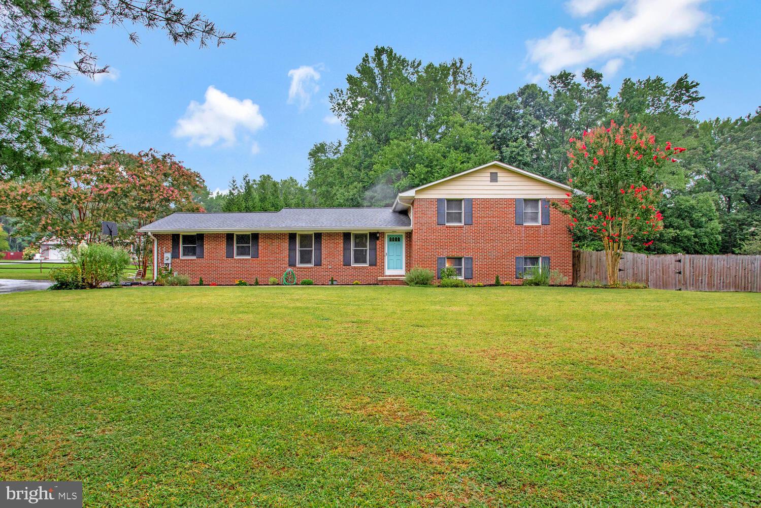 1110 Cox Road Huntingtown, MD 20639 - Photo 1 of 20 a front view of a house with a garden