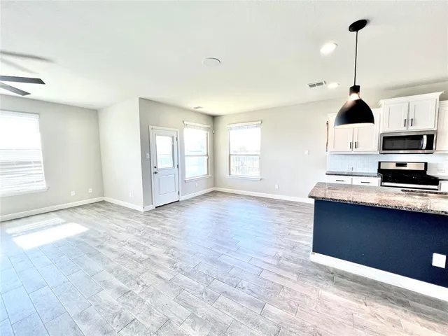 a view of kitchen with furniture and wooden floor