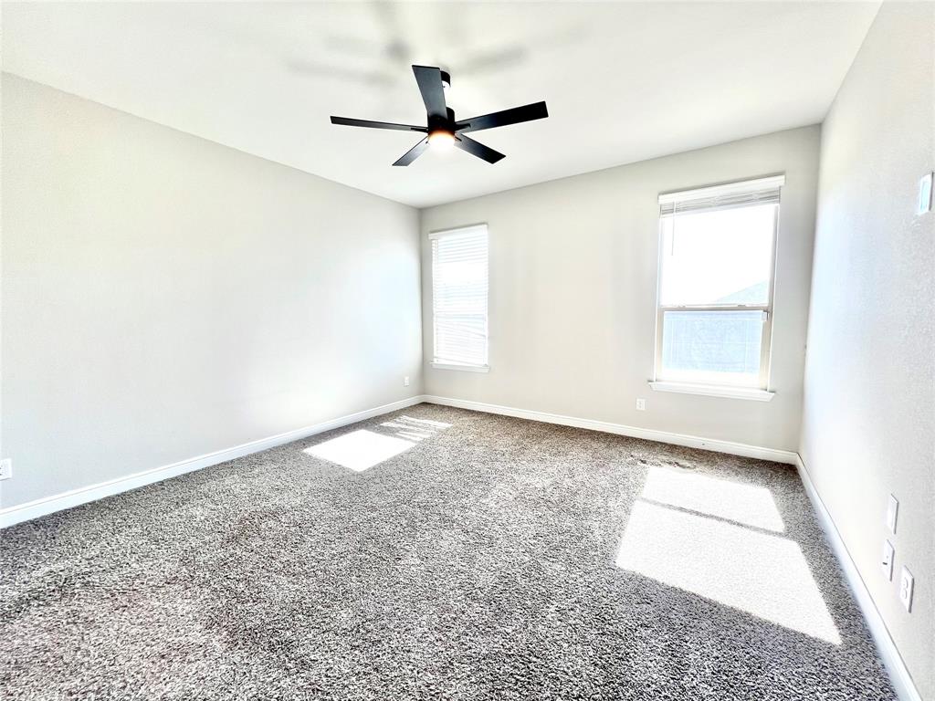 1600 Reed Drive Krum, TX 76249 - Photo 20 of 28 an empty room with a ceiling fan and window