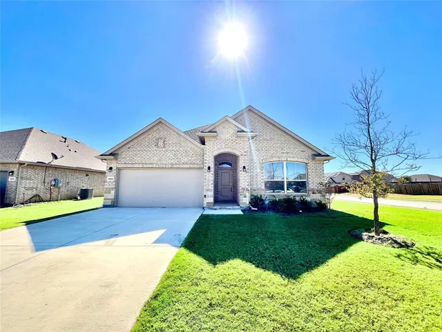 a view of a house with a yard and garage