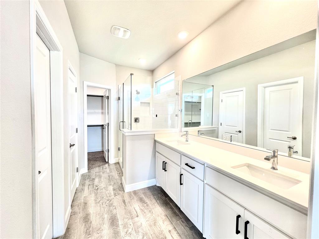 1600 Reed Drive Krum, TX 76249 - Photo 22 of 28 a large bathroom with a double vanity sink and mirror with shower