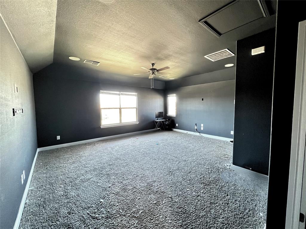 1600 Reed Drive Krum, TX 76249 - Photo 24 of 28 an empty room with a ceiling fan and window