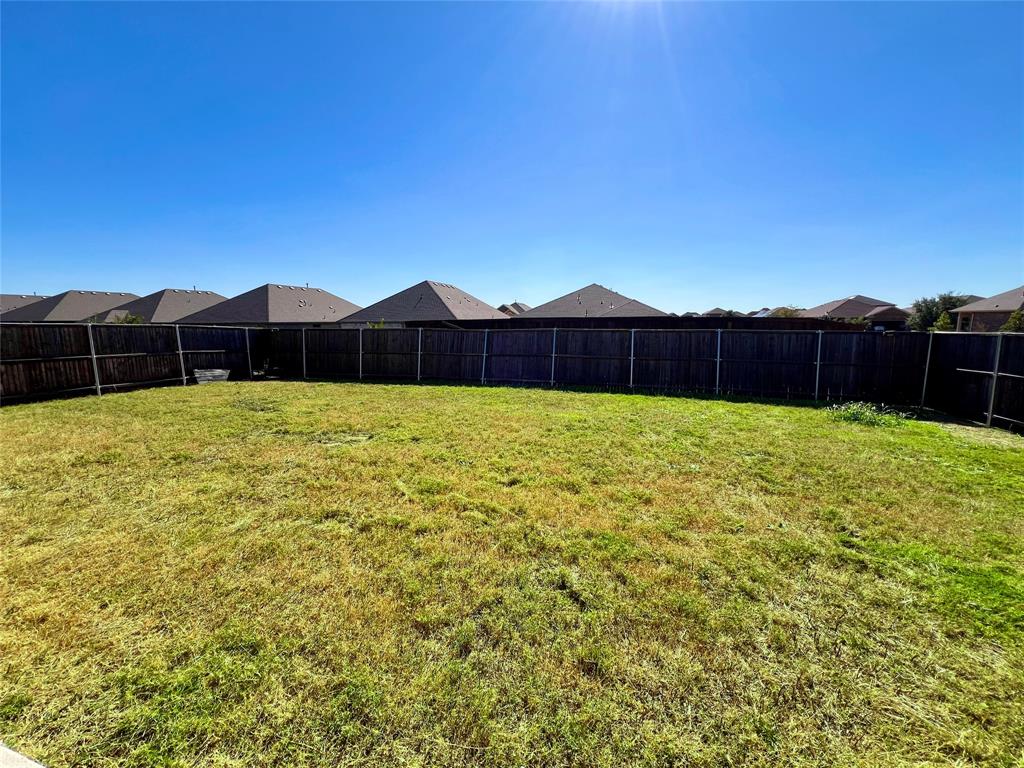1600 Reed Drive Krum, TX 76249 - Photo 27 of 28 a view of a backyard with potted plants and wooden fence