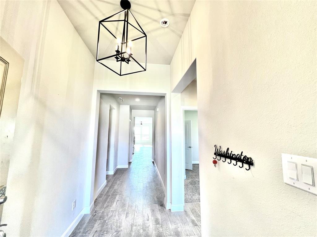 1600 Reed Drive Krum, TX 76249 - Photo 3 of 28 a view of a hallway with wooden floor and dining room