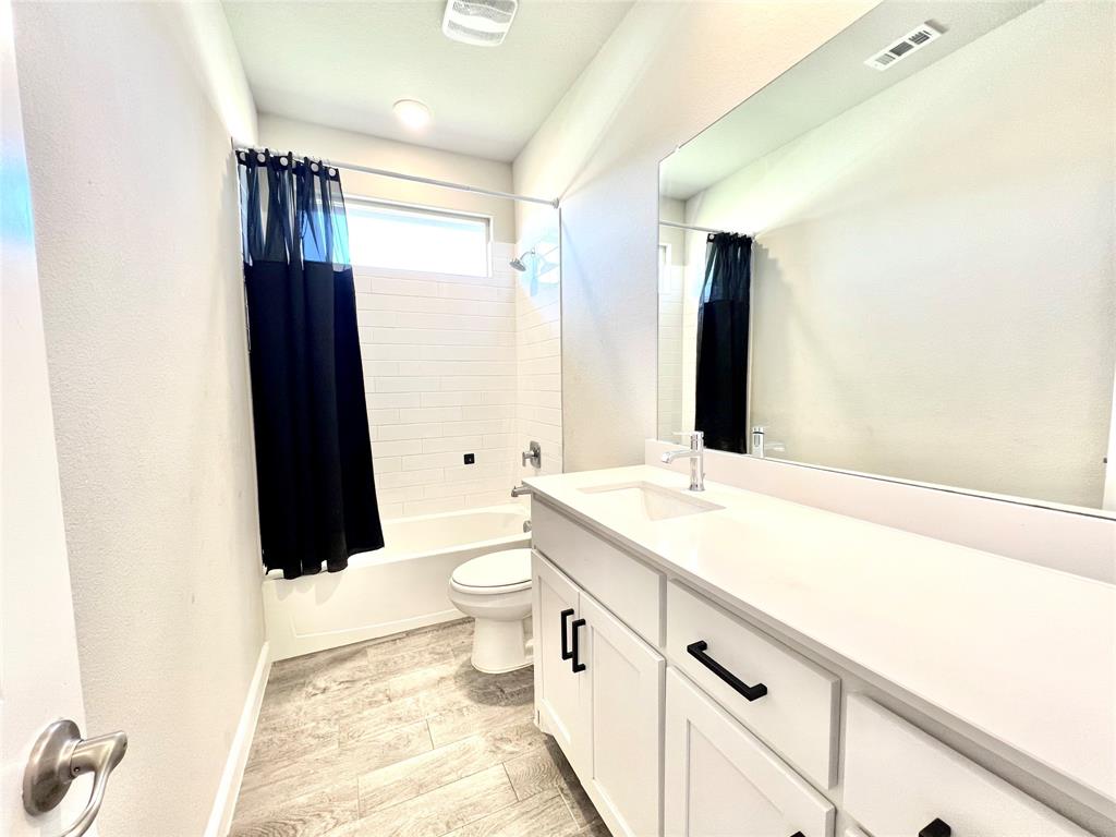 1600 Reed Drive Krum, TX 76249 - Photo 6 of 28 a bathroom with a sink a toilet a tub and shower