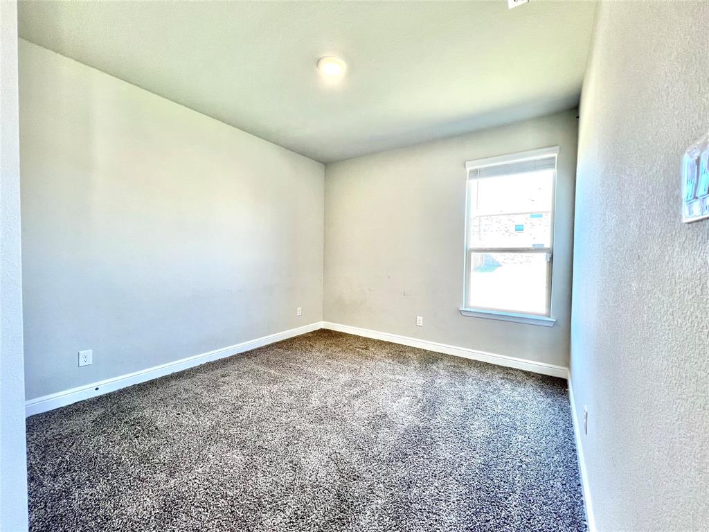 1600 Reed Drive Krum, TX 76249 - Photo 7 of 28 an empty room with a empty space and a window