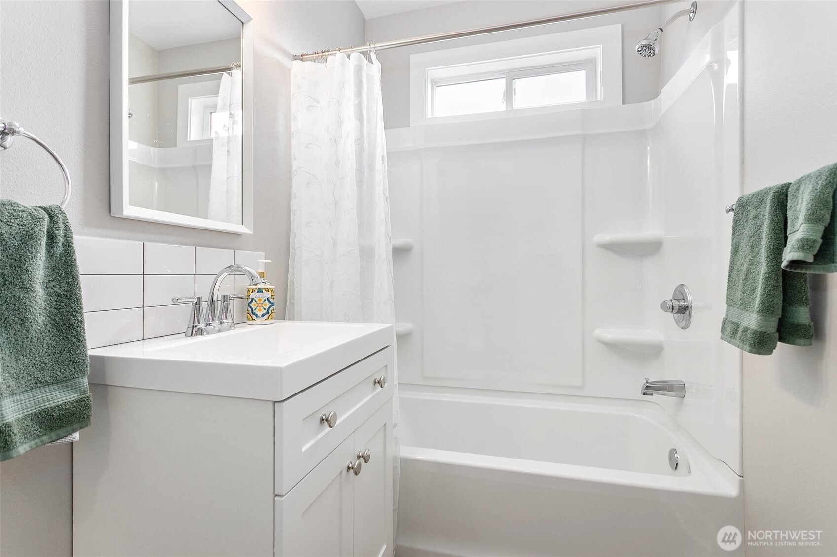 605 Alabama Street Bellingham, WA 98225 - Photo 14 of 27 a bathroom with a sink a mirror and a bathtub