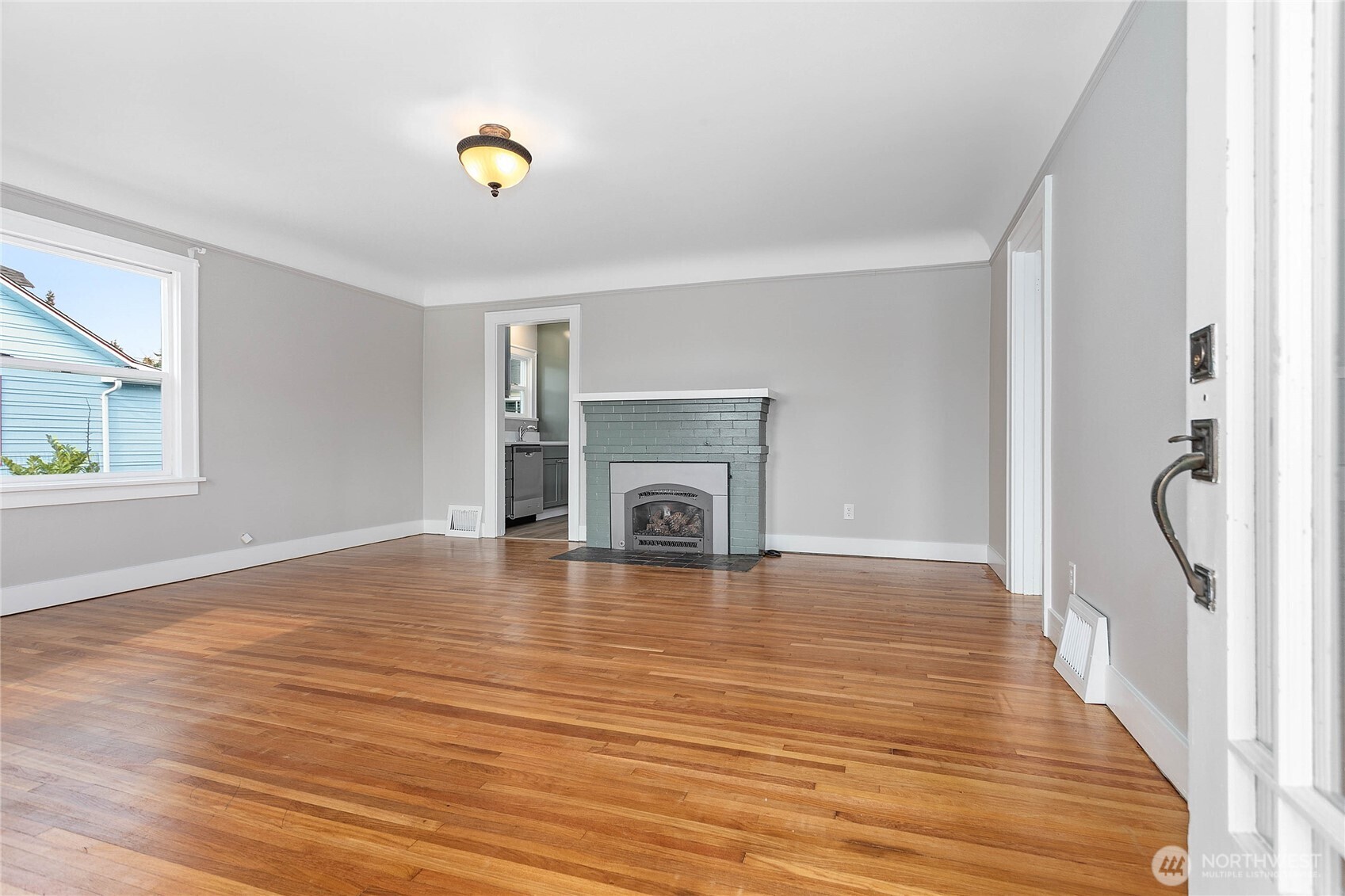 605 Alabama Street Bellingham, WA 98225 - Photo 2 of 27 a view of an empty room with wooden floor and a window
