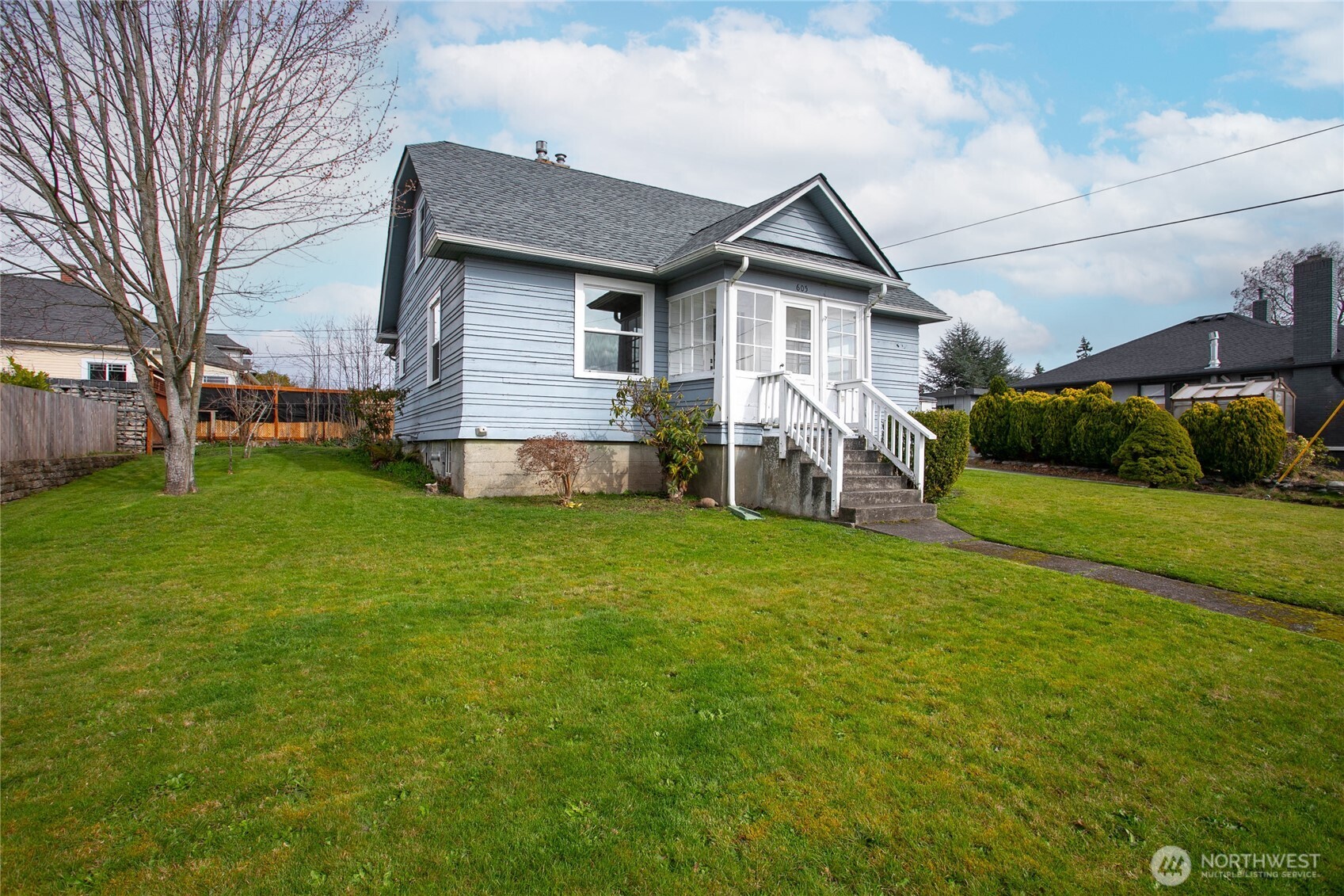 605 Alabama Street Bellingham, WA 98225 - Photo 27 of 27 a view of a house with a big yard and large trees