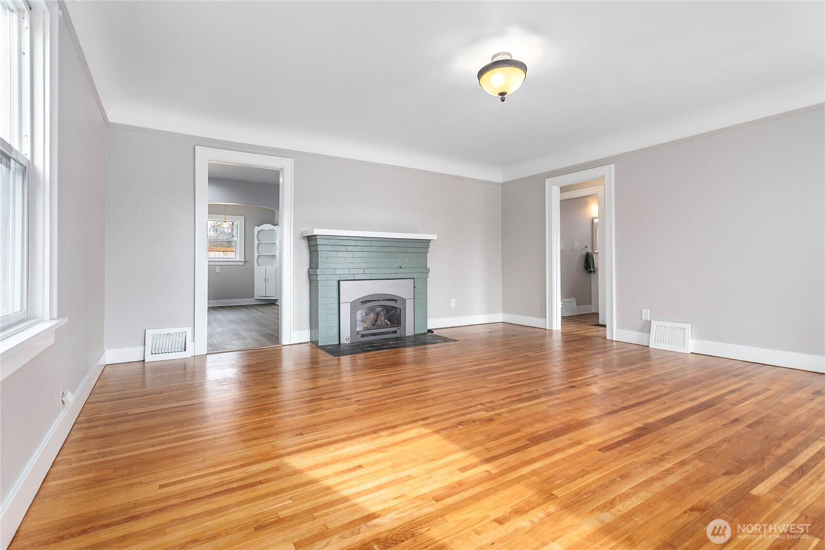 605 Alabama Street Bellingham, WA 98225 - Photo 3 of 27 a view of empty room with kitchen and fireplace