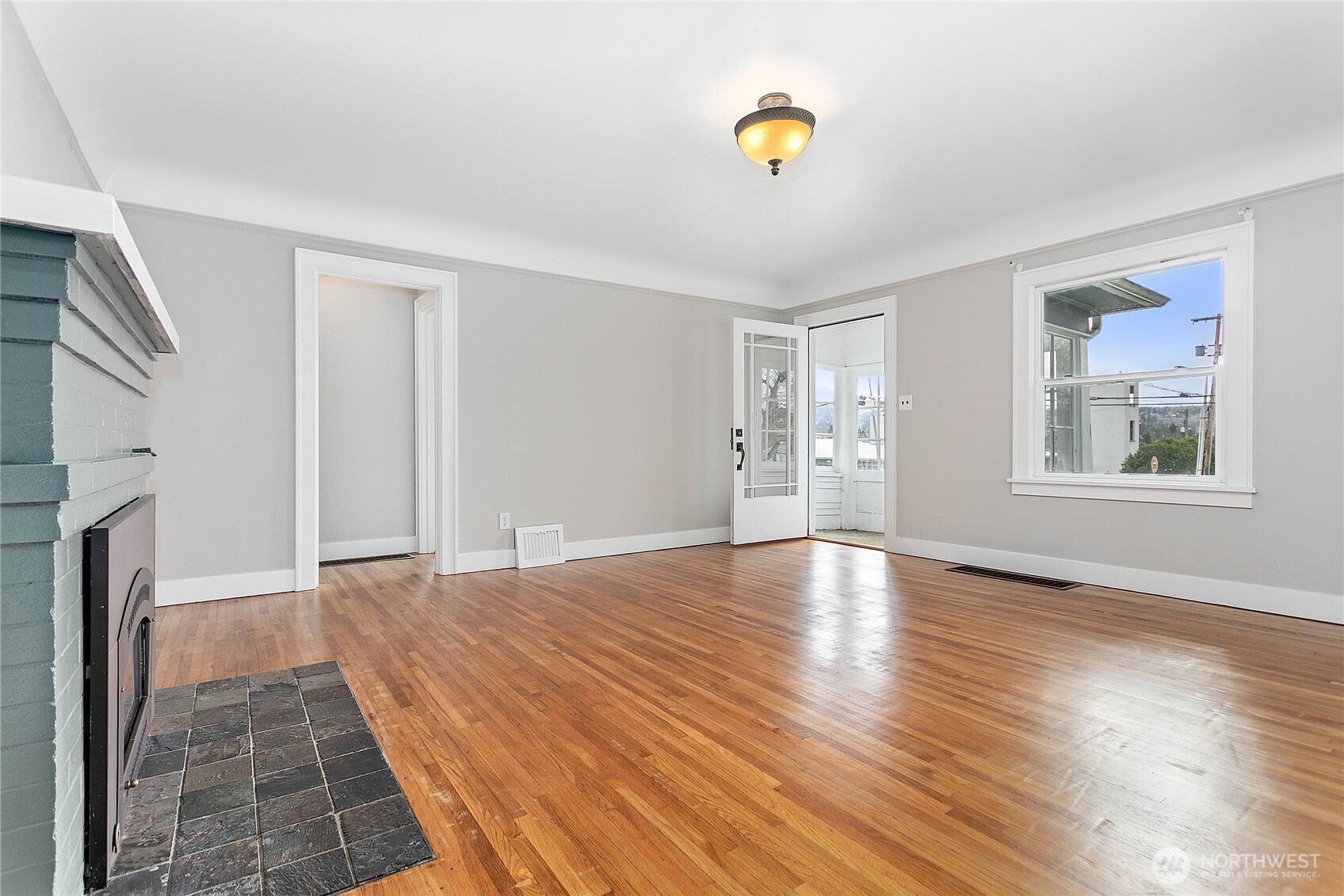 605 Alabama Street Bellingham, WA 98225 - Photo 4 of 27 a view of an empty room with window and wooden floor