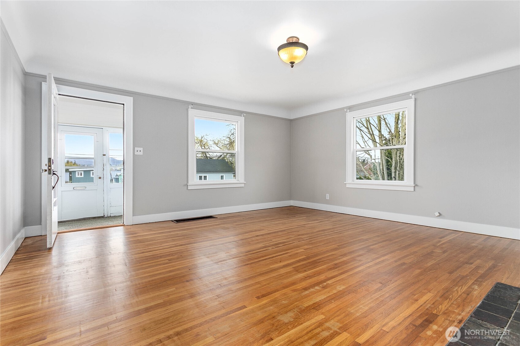 605 Alabama Street Bellingham, WA 98225 - Photo 5 of 27 an empty room with window and wooden floor