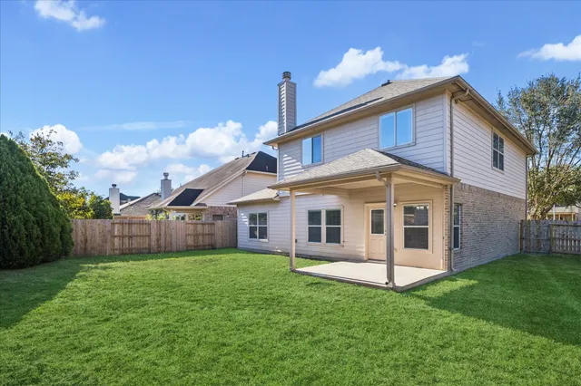 a view of a house with a backyard