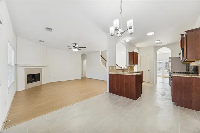 a view of a kitchen with a sink and a chandelier