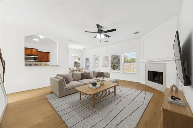 a living room with furniture a fireplace and a flat screen tv