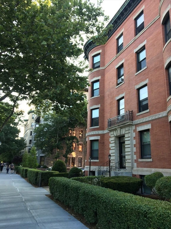 1064 Beacon Street, Unit 9 Brookline, MA 02446 - Photo 18 of 19 a view of a building with a yard