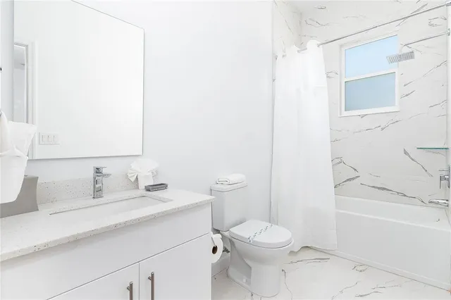 a dining room with furniture and a window