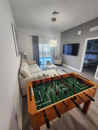 a living room with furniture and kitchen view