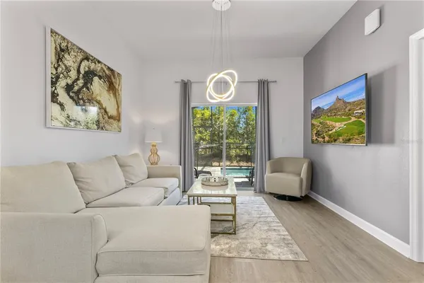 a kitchen with stainless steel appliances granite countertop a refrigerator a stove a sink dishwasher and white cabinets with wooden floor