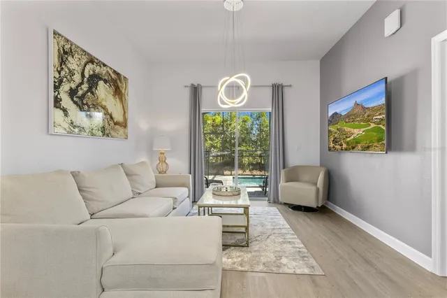 a kitchen with stainless steel appliances granite countertop a refrigerator a stove a sink dishwasher and white cabinets with wooden floor