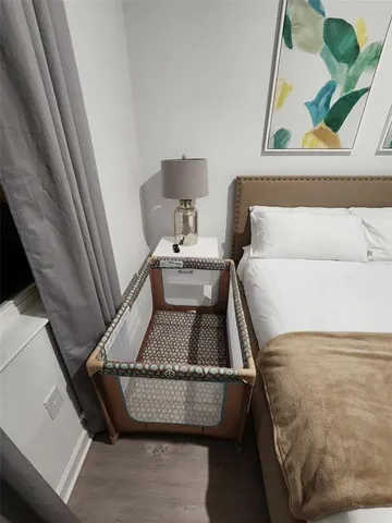 a large white bed sitting in a bedroom and lamp