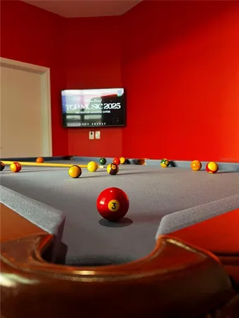 a kitchen with kitchen island a dining table chairs refrigerator and microwave