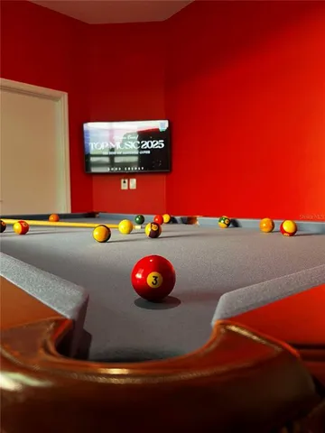 a kitchen with kitchen island a dining table chairs refrigerator and microwave