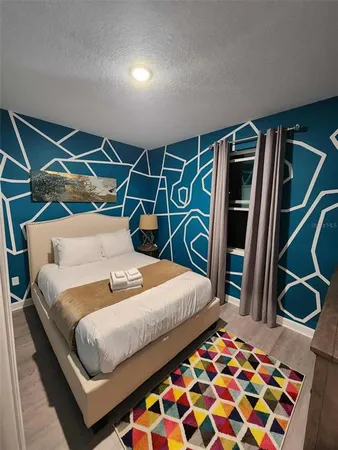 a bedroom with two beds and a large mirror
