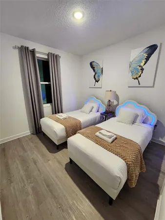 a bedroom with a bed and flat screen tv