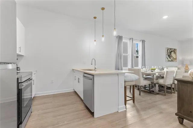 a room with painting and a potted plant