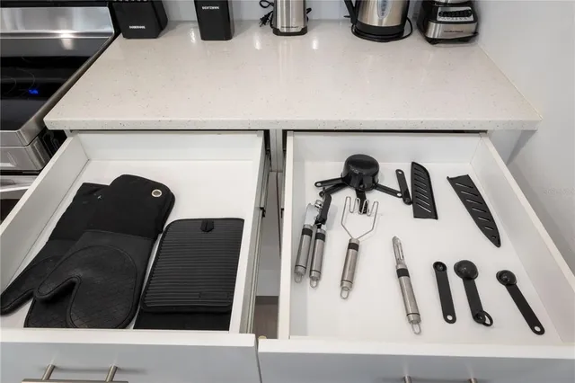 a kitchen with granite countertop a refrigerator and a sink