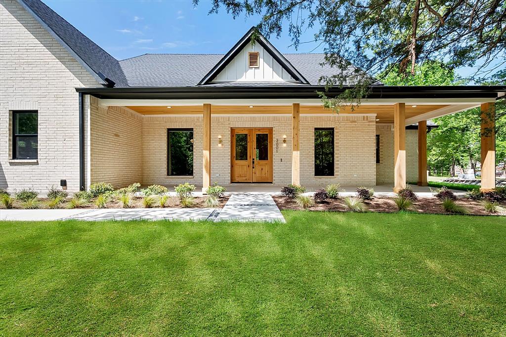 a front view of a house with yard and green space