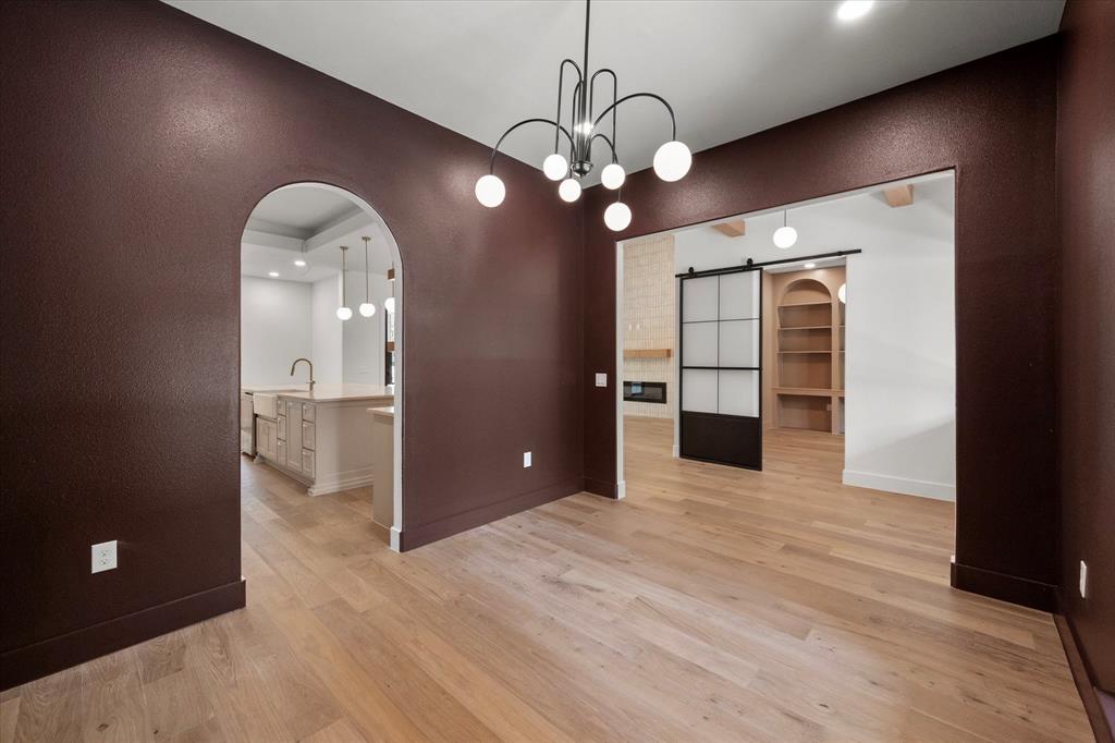 3001 Rock Road Corsicana, TX 75109 - Photo 18 of 40 a view of a hallway with wooden floor and a chandelier