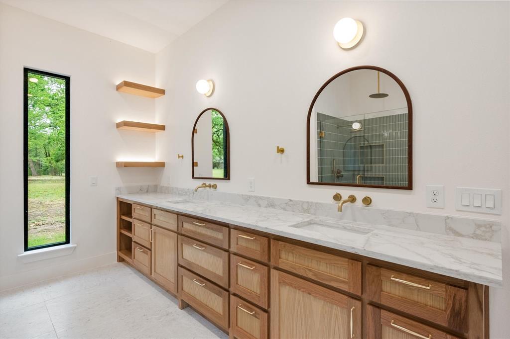 3001 Rock Road Corsicana, TX 75109 - Photo 25 of 40 a bathroom with a granite countertop sink a large mirror and a window