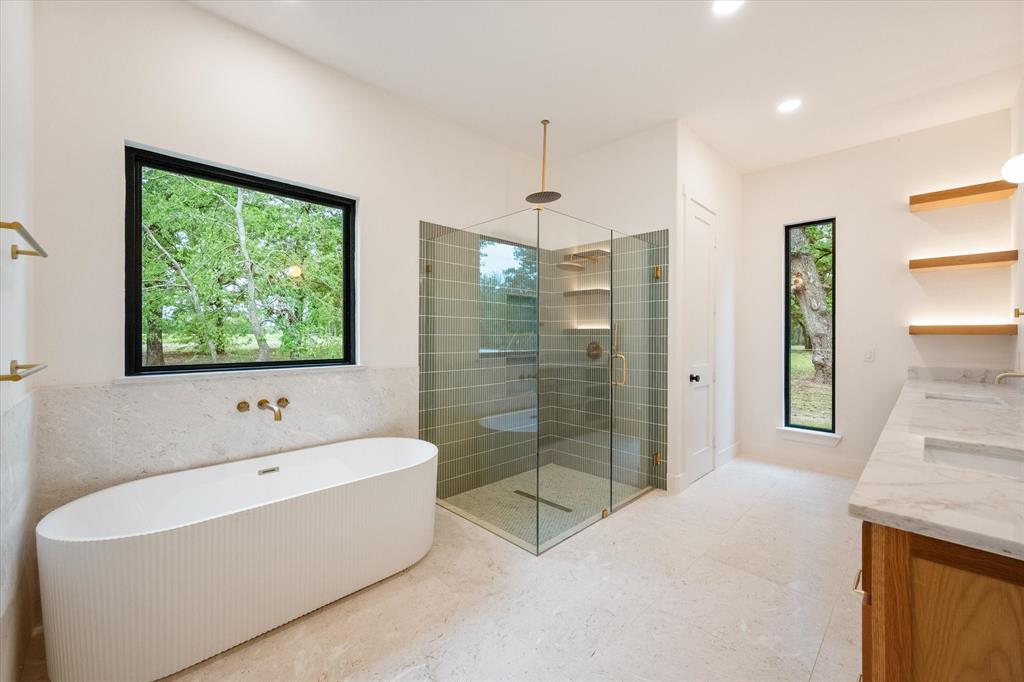 3001 Rock Road Corsicana, TX 75109 - Photo 26 of 40 a bathroom with a bathtub and a shower
