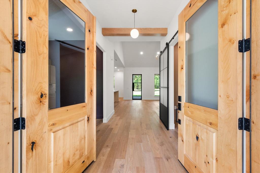 3001 Rock Road Corsicana, TX 75109 - Photo 4 of 40 a view of a hallway with wooden floor and staircase