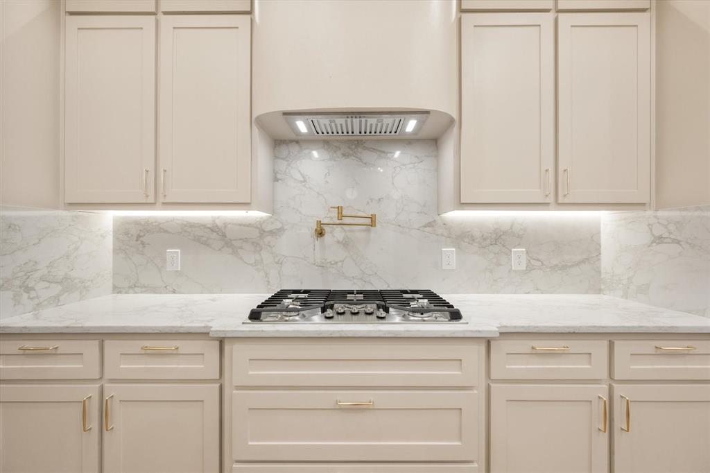 3001 Rock Road Corsicana, TX 75109 - Photo 10 of 40 a kitchen with white cabinets and a stove with wooden floor