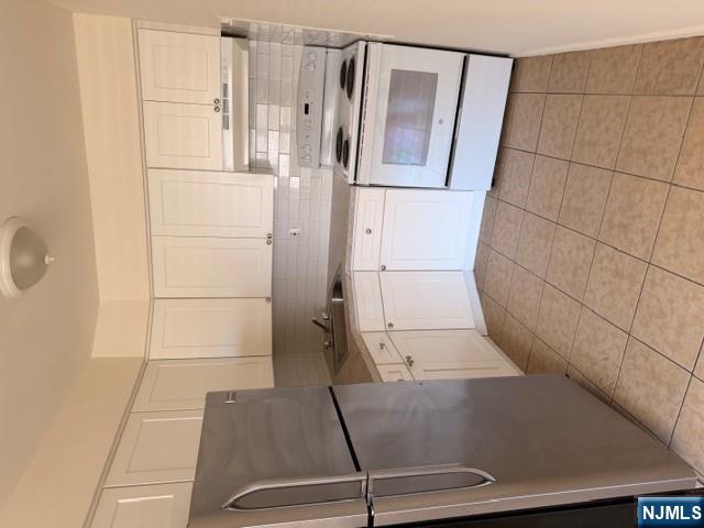 a kitchen with stainless steel appliances granite countertop a sink and a refrigerator