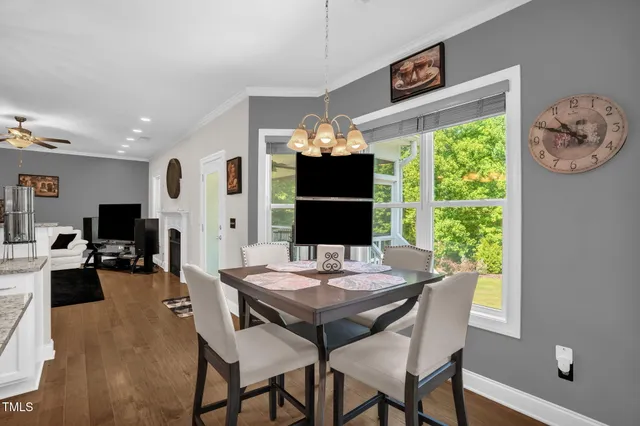 a view of a dining room with furniture window and wooden floor