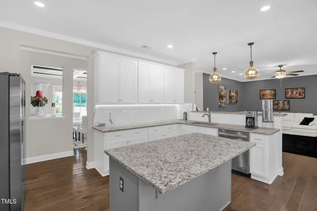 a kitchen with kitchen island a sink stove and wooden cabinets