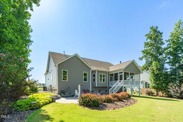 a front view of house with yard outdoor seating and green space