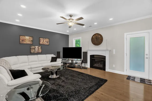 a living room with furniture a fireplace and a flat screen tv