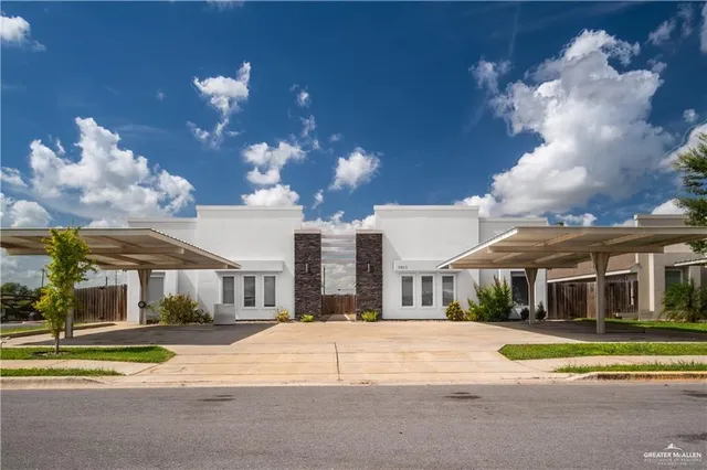 a view of a white building with a swimming pool